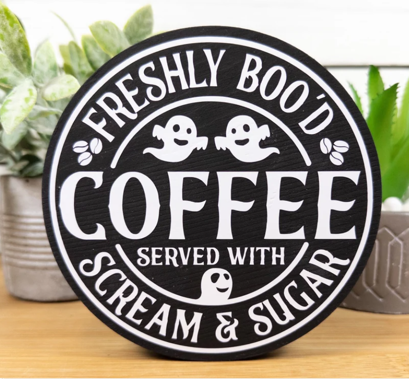 Wooden sign that reads "Freshly Boo'd Coffee " with friendly ghosts
